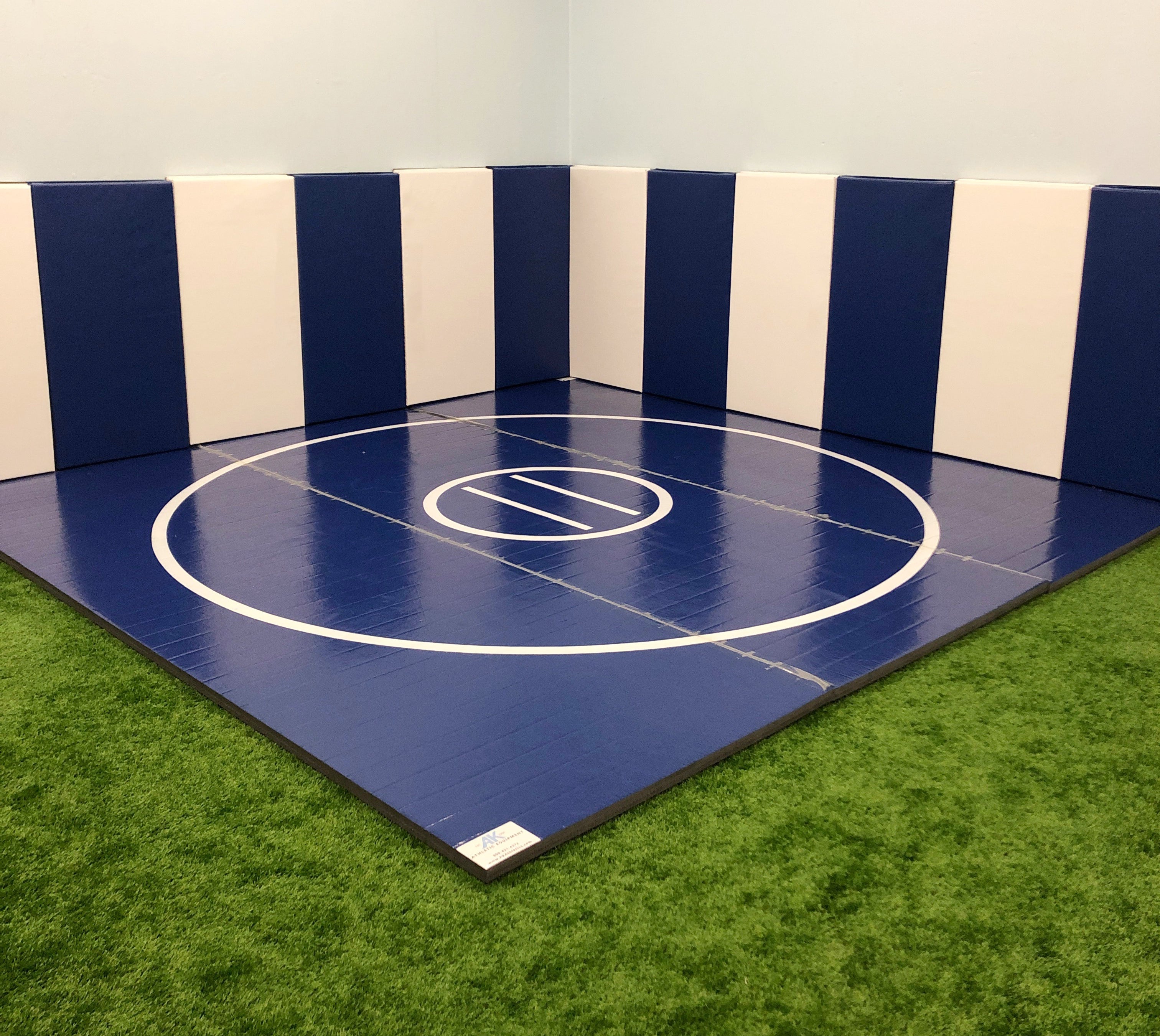 Training Wrestling Mat in Corner With Protective Wall Padding. Customize the size and look with digitally printed wrestling mats.