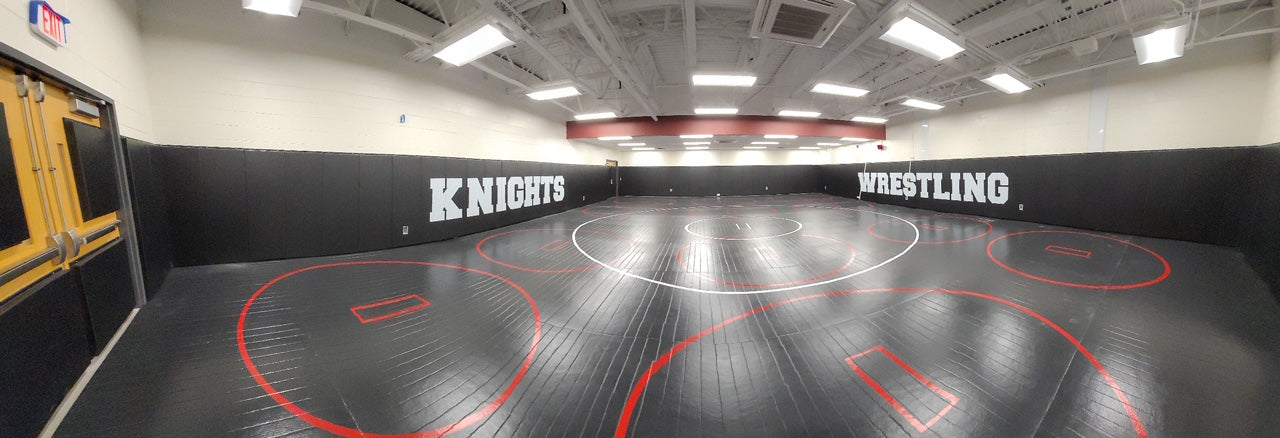 High School Wrestling Room with Wrestling Mat and Wall Pads 