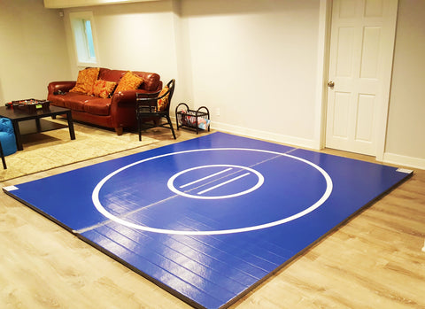 Blue home wrestling mat 10' x '10 with white wrestling circles 