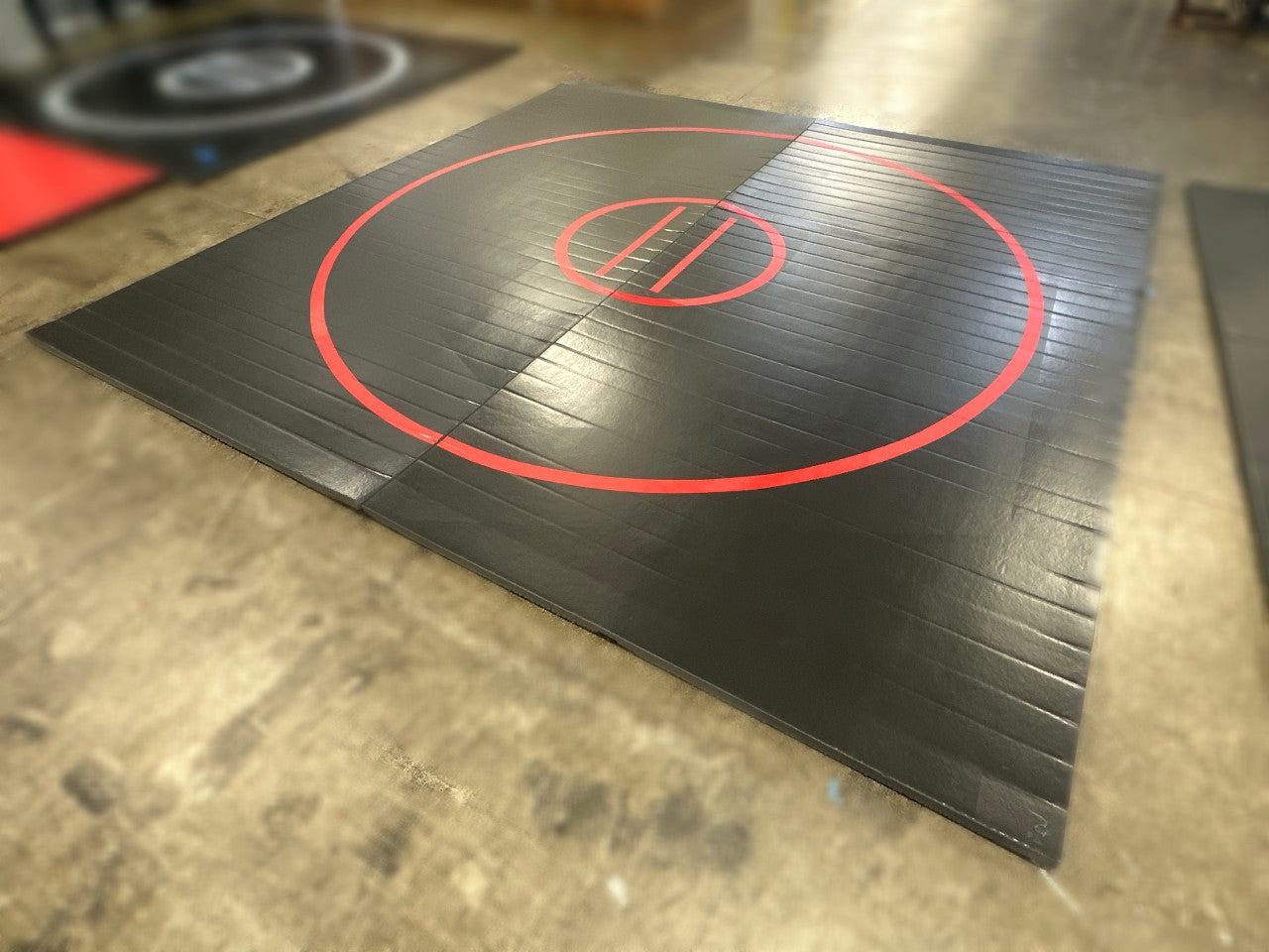 Clearance 12' x 12' x 1 5/8" UltraShock Roll-Up Wrestling Mat - Black Mat with Red Circles and Lines