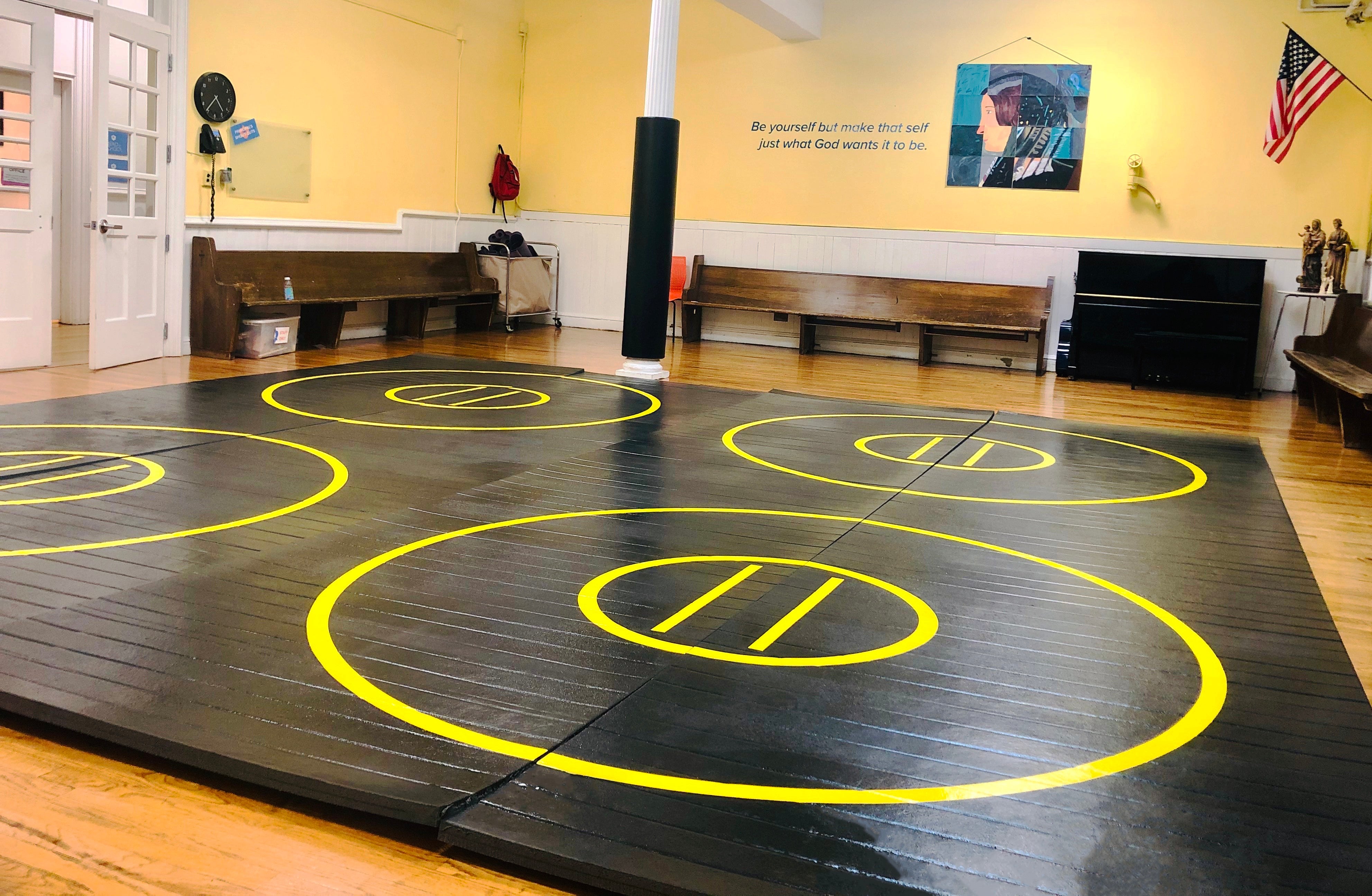 Black and Yellow Wrestling Mat in Martial Arts Studio