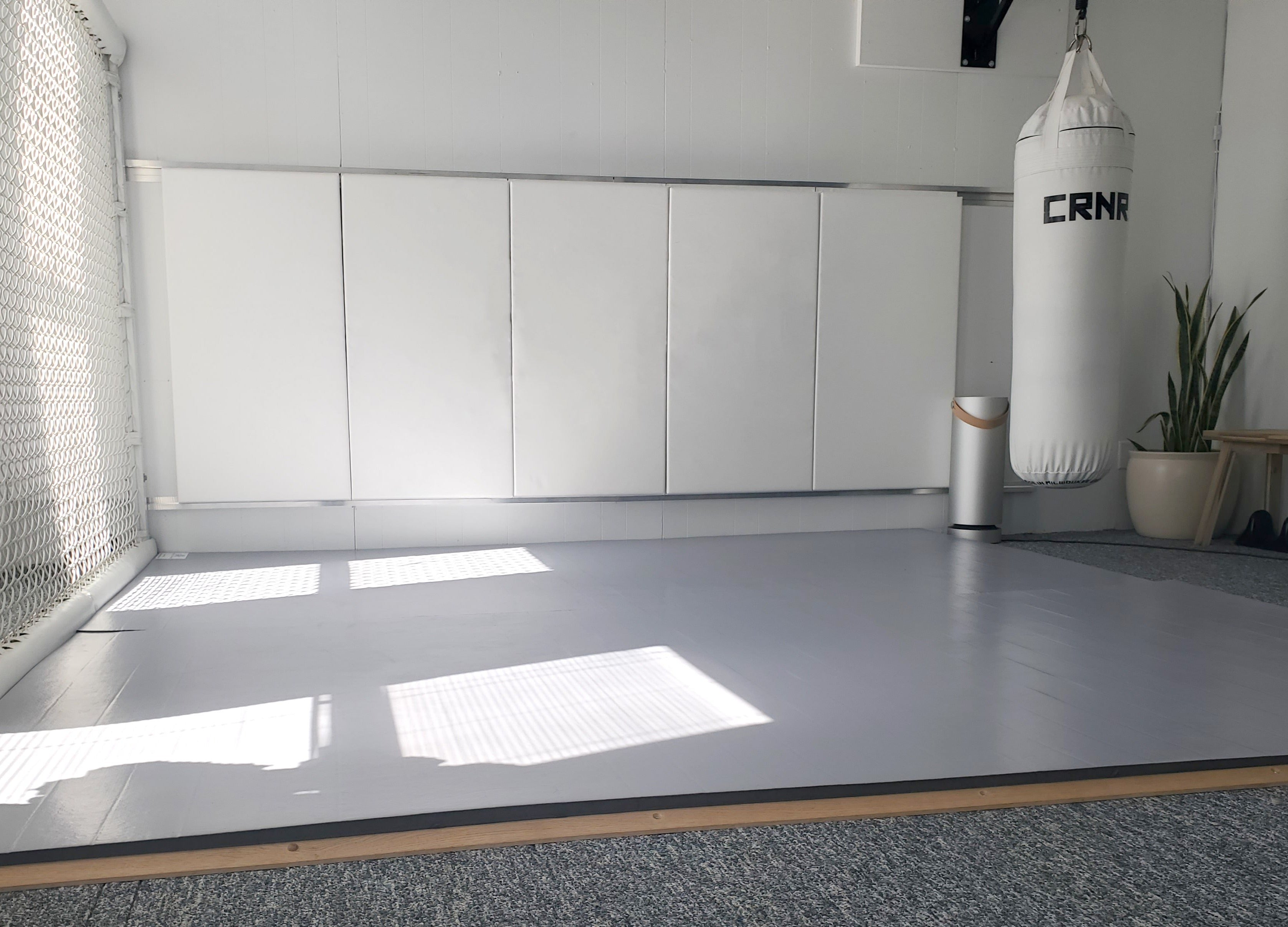 Home MMA Gym feature AK Athletics Grey Wrestling Mats and White Wall Pads