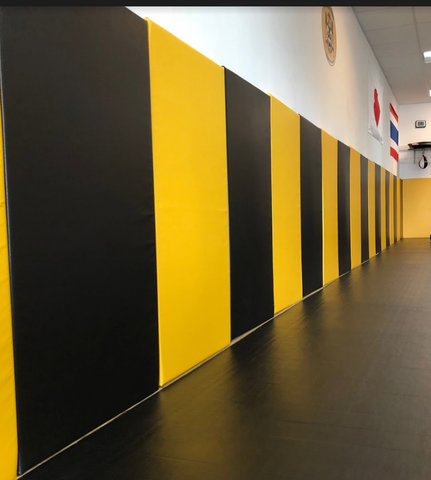 Black and yellow removable wall pads for renting martial arts gym, gym wall padding, gym wall pads, gym pads, wall padding, basketball wall padding, wall mats, gym wall padding